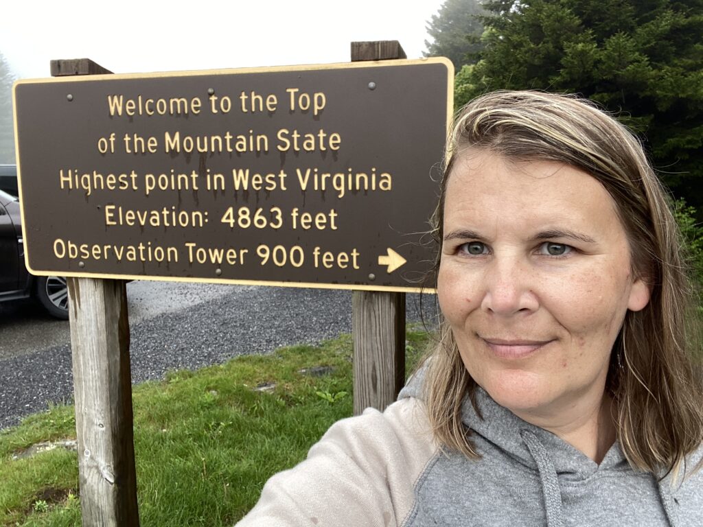 Standing in front of the sign for Spruce Knob