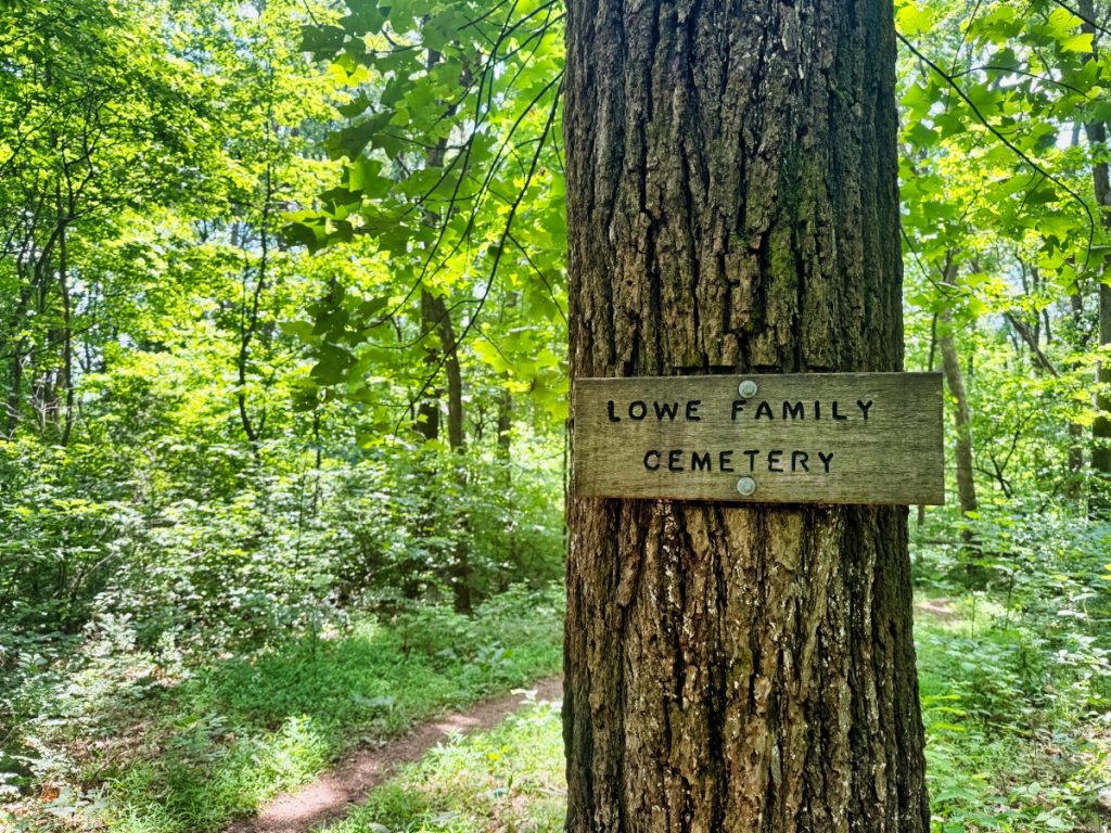 sign for the Lowe Family Cemetery nailed to a tree