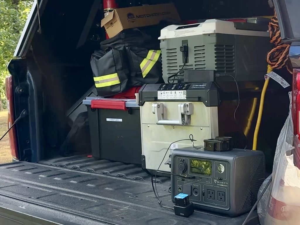 bodega 47qt m45 cooler in the bed of a truck surrounded by other totes and luggage