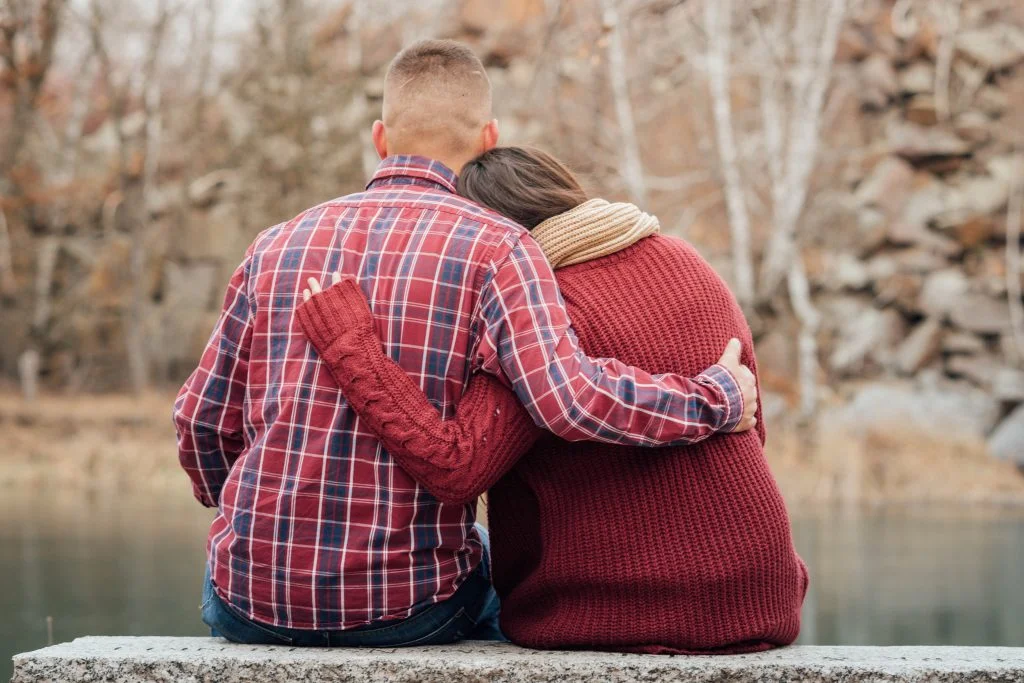 Couple sitting on a dock