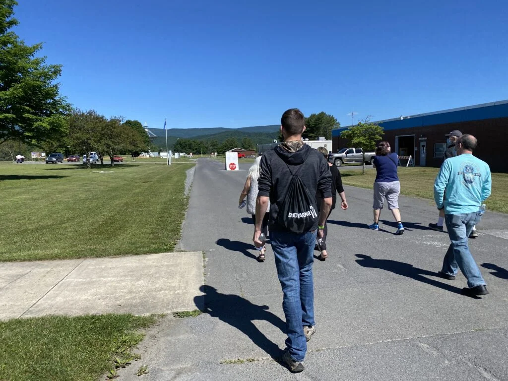 green bank observatory - people walking on a road for the guided tour