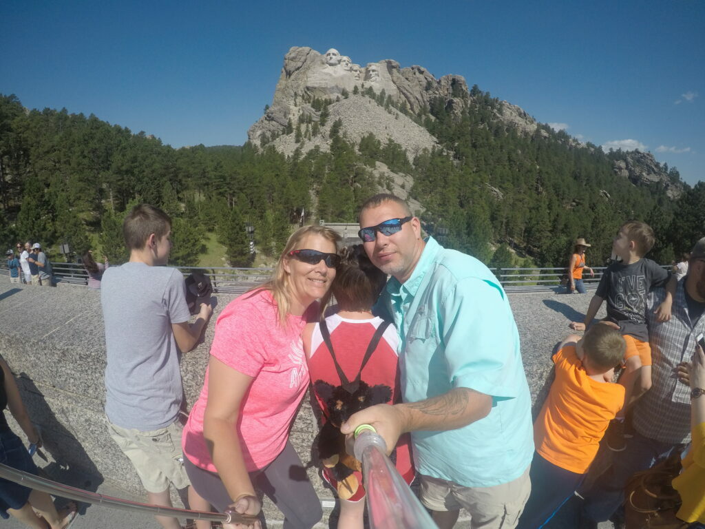 Our family photo in front of Mount Rushmore