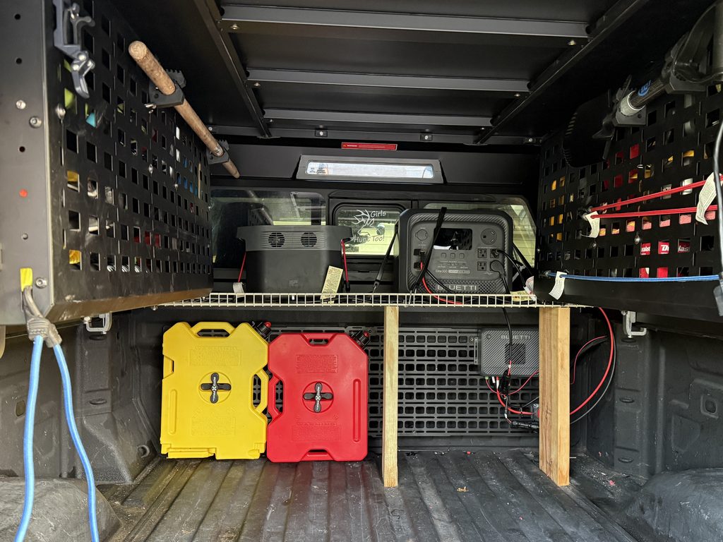 looking inside the bed of a truck with power banks and gas cans