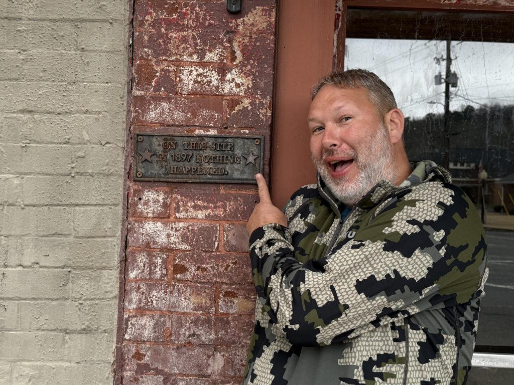 funny sign on a historic building in cave spring georgia