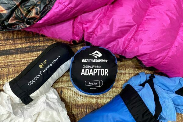 sleeping bag liners next to a quilt