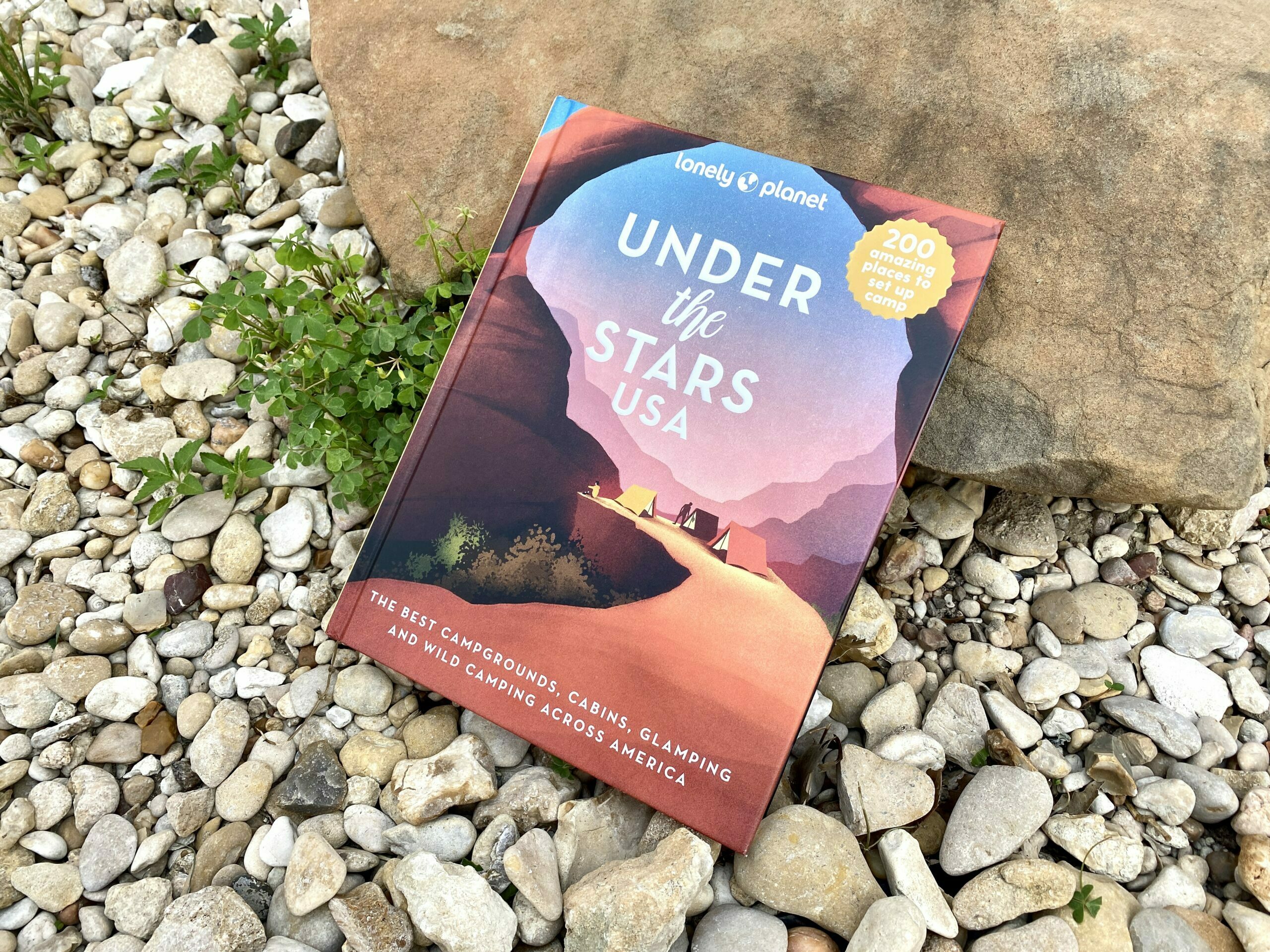 Under the Stars USA book propped up on a rock